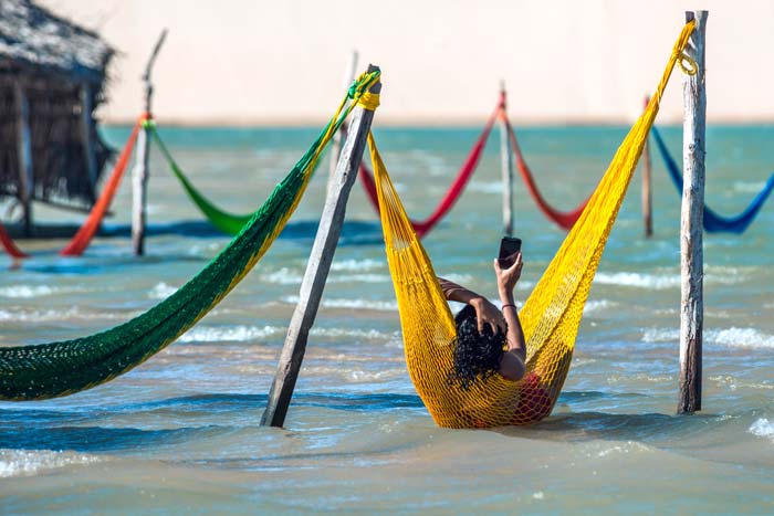 Woman chilling on hammock in Jericoacoara lagoon