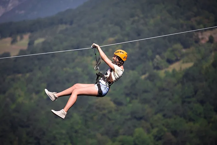 Woman gliding in zip line in Pedra Bela