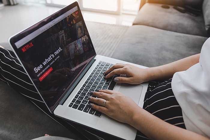 Woman watching Brazilian movies on Netflix