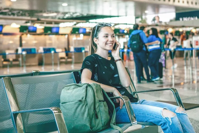 Girl talking on the phone at airport using a Brazil SIM card