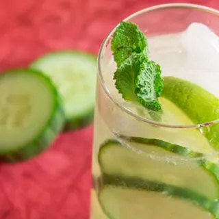 Cucumber caipiroska drink surrounded by cucumber slices