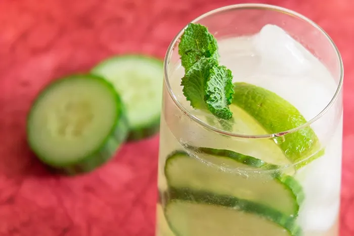 Cucumber caipiroska drink surrounded by cucumber slices