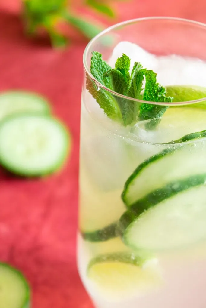 Cucumber caipiroska drink surrounded by cucumber slices
