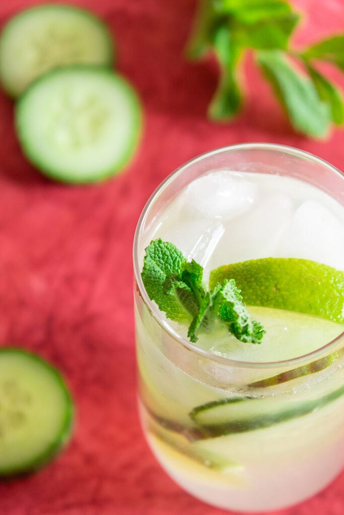 Cucumber caipiroska drink surrounded by cucumber slices