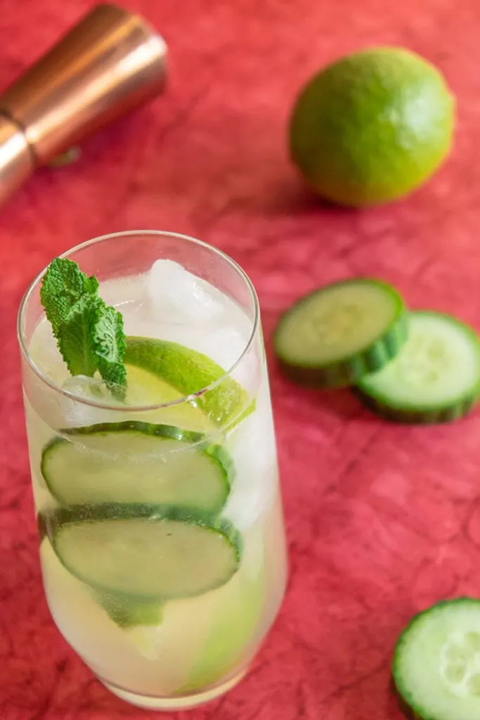 Cucumber caipiroska drink surrounded by cucumber slices