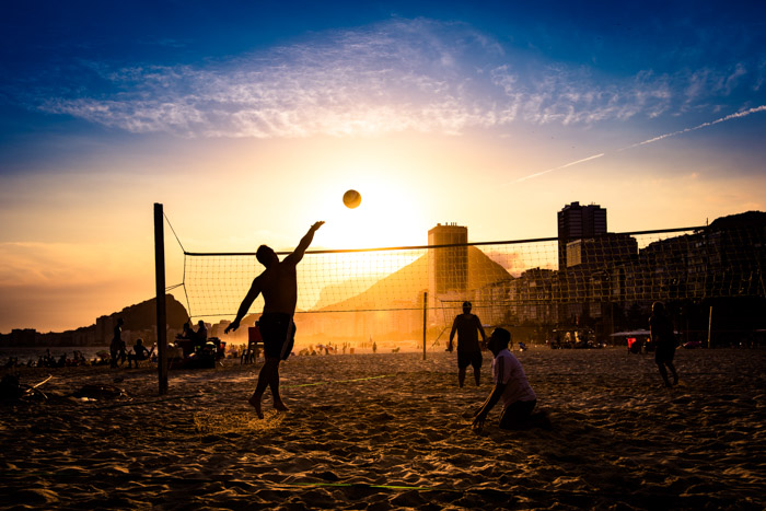 Brazilians playing volleyball at the beach in Rio