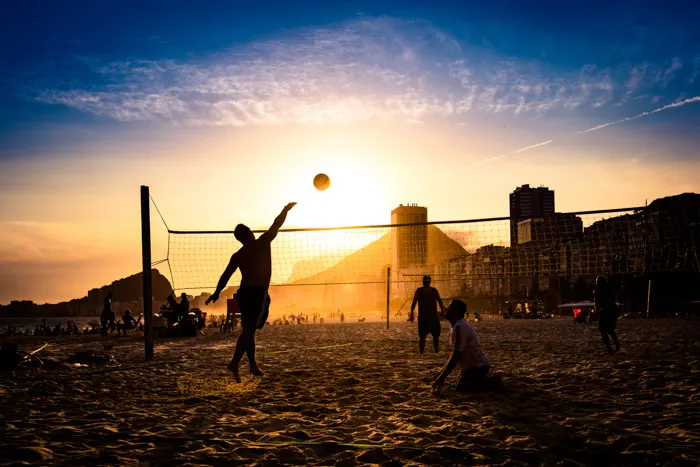 Brazilians playing volleyball at the beach in Rio