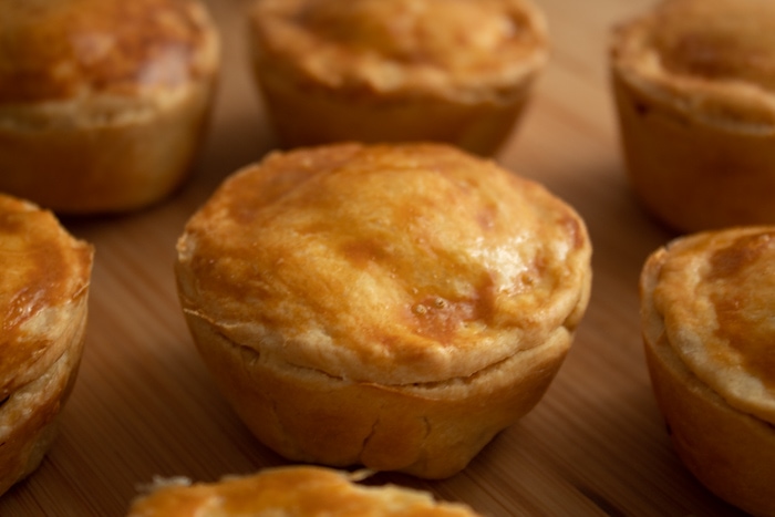 Chicken hand pies on a wooden cutting board