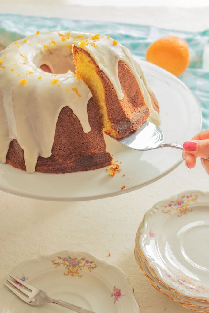 Hand getting a piece of Brazilian orange cake