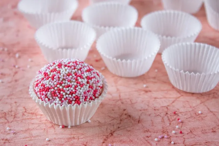 Strawberry brigadeiro near empty white cups