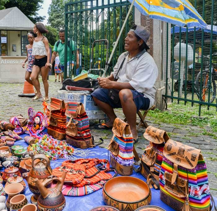 Indigenous Brazilian man selling arts and crafts at a street market in Belo Horizonte