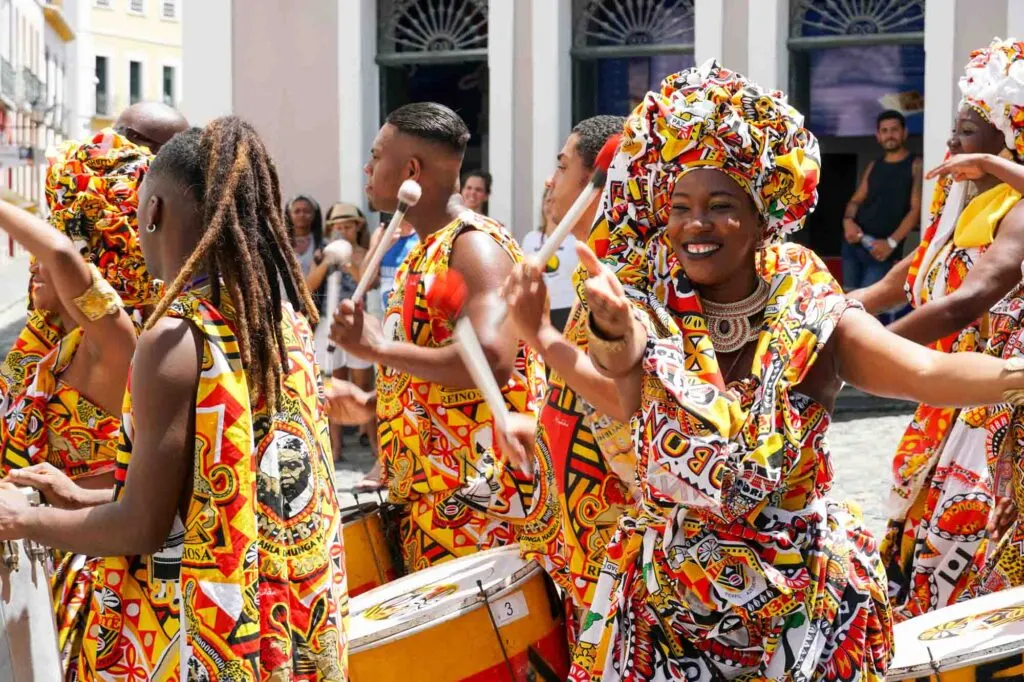 Dancer's small parade with traditional costumes celebrating with revelers the Carnival on the streets in Salvadore, Bahia, Brazil.