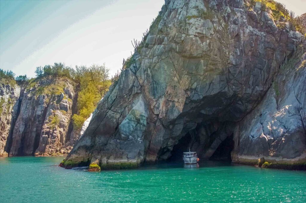 Boat leaving Gruta Azul, blue cavern, in Arraial do Cabo, Brazil