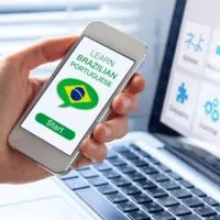 Man holding a mobile and learning Brazilian Portuguese on an app