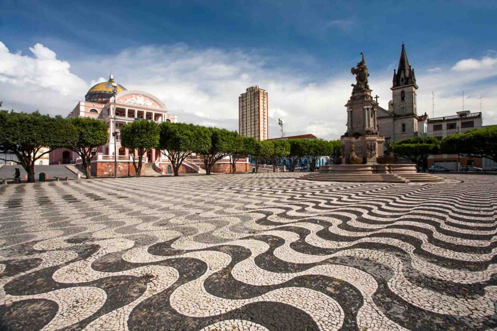 Manaus city sidewalk with Amazon theatre and church