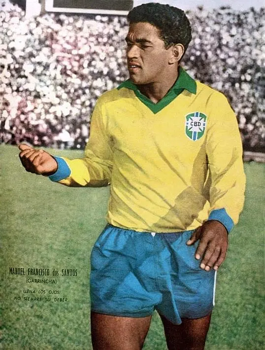 Garrincha, a soccer player from Brazil, walking on field
